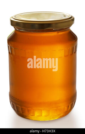 Closed jar of honey on white background Stock Photo