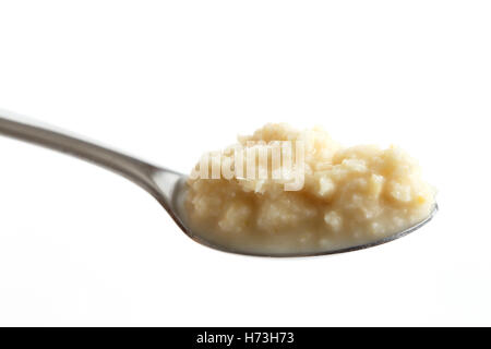 Spoon of horseradish sauce in perspective isolated on white. Stock Photo