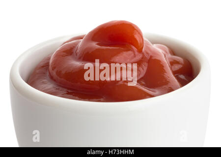 Ketchup in white ceramic ramekin. White background. Stock Photo