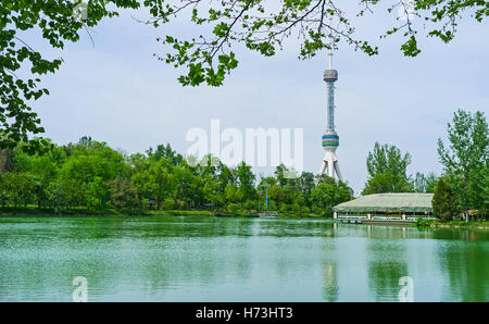 The scenic view of Anchor Canal with the lush gardens on its banks and TV tower in the background, Tashkent, Uzbekistan Stock Photo