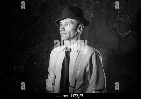 Black and white picture of handsome private detective. Agent stay front to camera. Criminal scene. He wears classic shirt. Studio shot Stock Photo