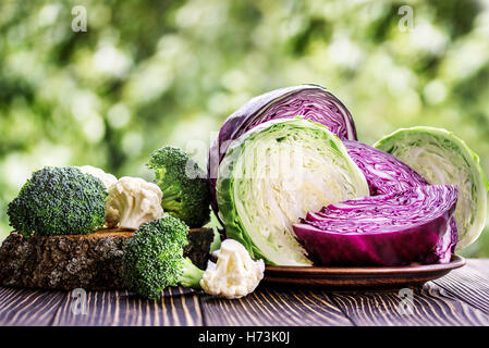 Still life with assortment cabbages on wooden background Stock Photo