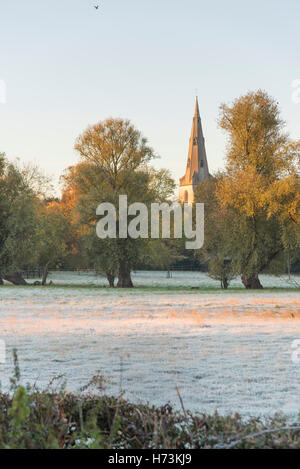 Overcote, Cambridgeshire UK, 2nd November 2016.  The steeple of the Church of St Mary glows in the morning light set in frosty meadows as the sun rises on a clear, crisp, frosty autumn morning. After a mild spell this is the first frost of this autumn in the East of the UK. Credit Julian Eales/Alamy Live News Stock Photo