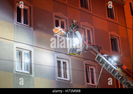 Munich, Germany. 02nd Nov, 2016. A firefighter transports a dead body on a gurney from a ladder at a deployment site in Munich, Germany, 02 November 2016. Three people were killed and ten other inured in a fire on Dachauer-Strasse. Photo: TOBIAS HASE/dpa/Alamy Live News Stock Photo