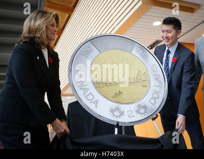 Richmond, Canada. 2nd Nov, 2016. Susan Dujmovic (L), Vice-Chair of the Royal Canadian Mint Board of Directors and Coin winning designer Timothy Hsia unveil the design of the 2017 two-dollars circulation coin in Richmond, Canada, Nov. 2, 2016. The Royal Canadian Mint unveiled its 2017 circulation coin serie. The winning designs are chosen from thousands of entries of the national coin design contest held in March 2015 inviting the public to create new designs for the 2017 circulation coin series celebrating Canada's 150th anniversary. © Liang Sen/Xinhua/Alamy Live News Stock Photo