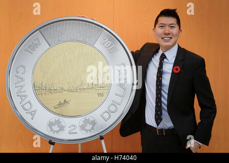 Richmond, Canada. 2nd Nov, 2016. Coin winning designer Timothy Hsia poses with a mock up of the new Royal Canadian two-dollars circulation coin in Richmond, Canada, Nov. 2, 2016. The Royal Canadian Mint unveiled its 2017 circulation coin series. The winning designs are chosen from thousands of entries of the national coin design contest held in March 2015 inviting the public to create new designs for the 2017 circulation coin series celebrating Canada's 150th anniversary. © Liang Sen/Xinhua/Alamy Live News Stock Photo