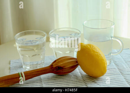 Fresh Lemon with wooden squeezer and lemonade Stock Photo