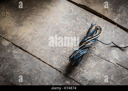 Multicolor electrical cables mixed on the old table Stock Photo