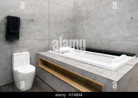 White round jacuzzi with swirling water in bathroom at hotel spa center. Interior bathroom in hotel. Stock Photo