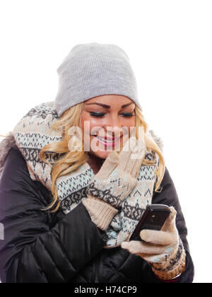 A attractive blond woman is laughing while looking at her cell phone. Stock Photo