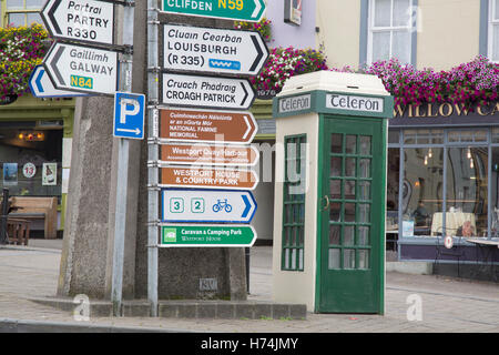 Traditional Telefon - Telephone Cabin and Street Direction Signs, Westport; Ireland Stock Photo