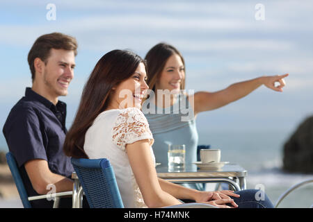 Group of friends looking at horizon in a restaurant Stock Photo