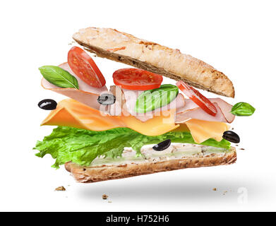 Ciabatta Sandwich with Lettuce, Tomatoes, Ham and Cheese cutted in half flying in the air Stock Photo