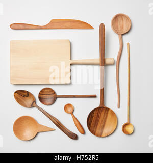 Wooden kitchen utensils on white background. Cutting board, fork, knife and spoon Stock Photo