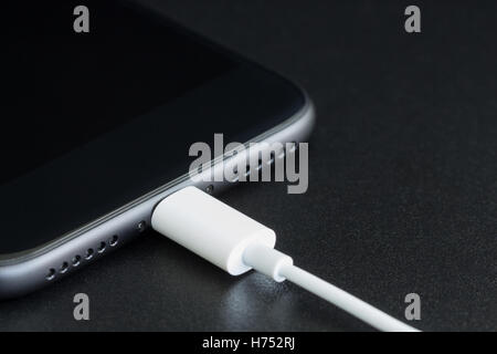 close-up lightning cable connect to phone Stock Photo