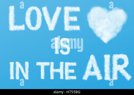 text Love is in the Air and heart cloud in the blue sky Stock Photo