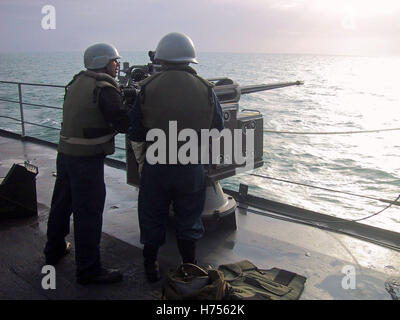 30th January 2003 Crew members man a .50 calibre machine-gun on the the USS Austin LPD-4 as it enters port in Bahrain.