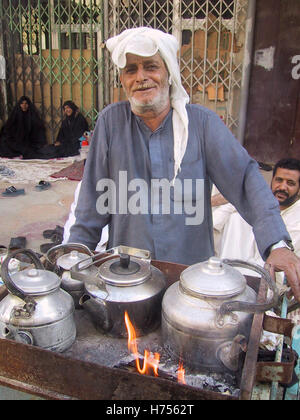 22nd April 2003 Near the main square, a tea-seller attends to several kettles on the boil during the Ashura in Karbala, Iraq. Stock Photo