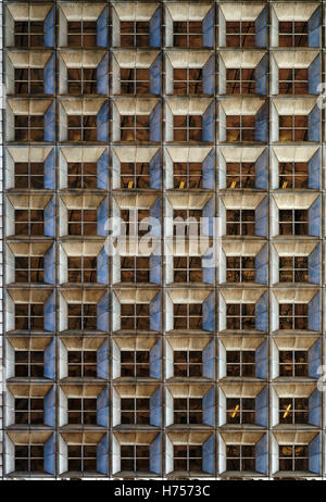 Office skyscraper windows at night time. Stock Photo