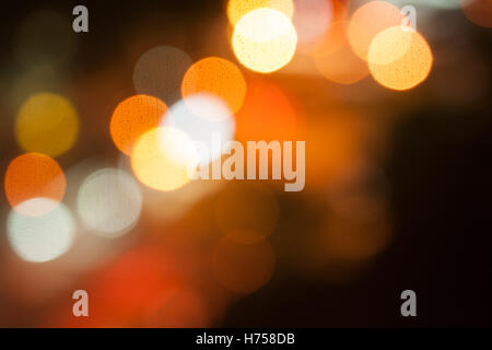 City lights big abstract circular bokeh on orange background. Stock Photo