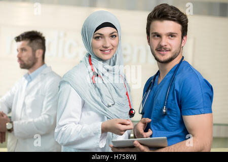 Saudi arab doctors working with a tablet. Stock Photo