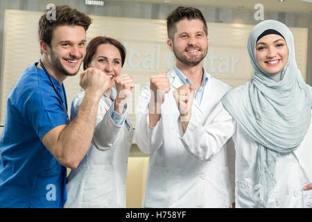 attractive male doctor in front of medical group Stock Photo