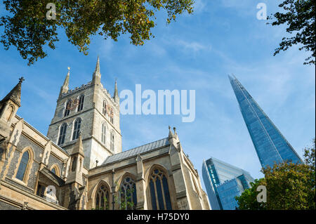 London skyline featuring the old architecture of the Southwark Cathedral with the modern Shard skyscraper beyond Stock Photo