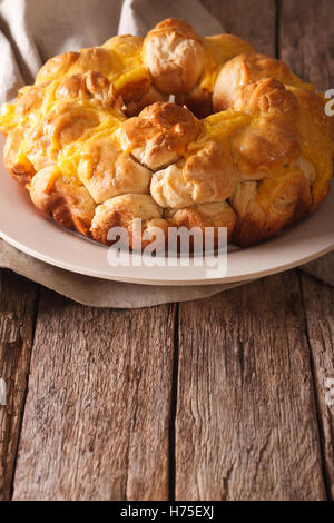 Homemade monkey bread with cheese on a plate on the table. vertical Stock Photo