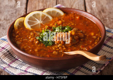 Thick Moroccan Harira soup in a bowl close-up on the table. Horizontal Stock Photo