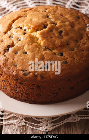 Homemade sponge cake with chocolate chips close-up on the table. Vertical Stock Photo