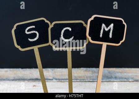 Business acronym SCM as Supply Chain Management written with chalk on wooden mini blackboard labels Stock Photo
