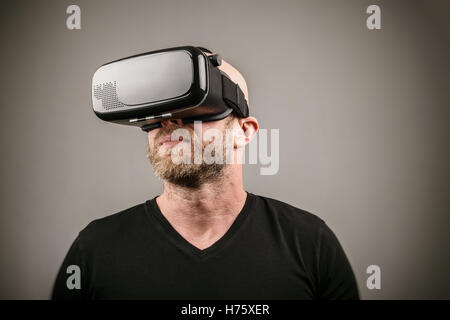 Bearded an wearing VR headset in a studio Stock Photo