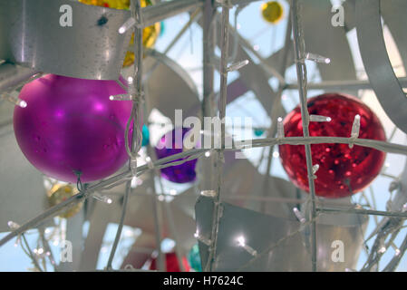 Christmas balls golden red blue purple steel cage Stock Photo