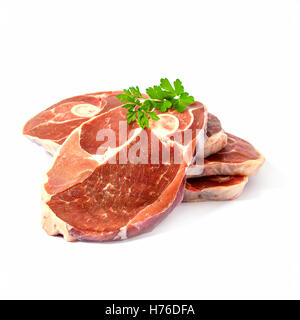 Four lamb slices with spice herbs, isolated, top view Stock Photo