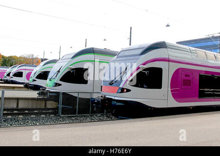 Five modern streamlined commuter trains at the railway station, detail. Stock Photo