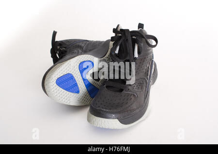 Children's modern high-top black leather and mesh basketball shoes,  sneakers showing the sole, isolated on white Stock Photo