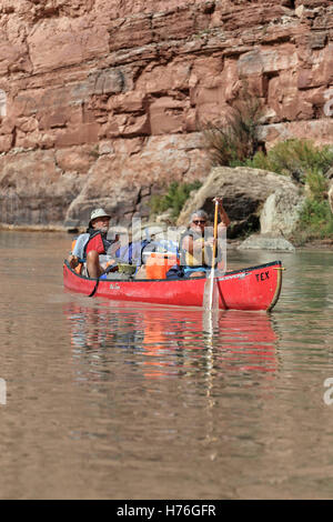An athletic elderly couple canoes on the Green River in Canyonlands National Park, Utah Stock Photo