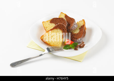slices of marble bundt cake on white plate Stock Photo