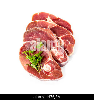 Four lamb slices with spice herbs, isolated, top view Stock Photo