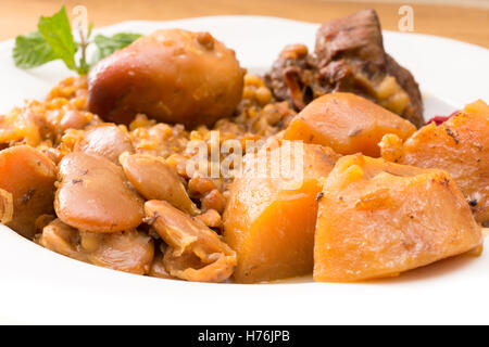 Traditional Jewish Cholent (Hamin) prepared is Israel as the main dish for the Shabbat meal made with beef, potato, beans, barle Stock Photo