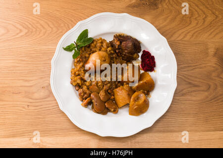 Traditional Jewish Cholent (Hamin) prepared is Israel as the main dish for the Shabbat meal made with beef, potato, beans, barle Stock Photo