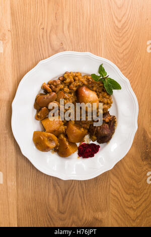 Traditional Jewish Cholent (Hamin) prepared is Israel as the main dish for the Shabbat meal made with beef, potato, beans, barle Stock Photo