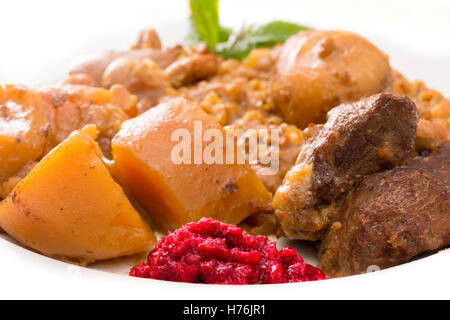 Traditional Jewish Cholent (Hamin) prepared is Israel as the main dish for the Shabbat meal made with beef, potato, beans, barle Stock Photo