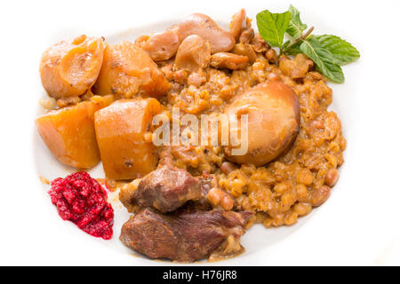 Traditional Jewish Cholent (Hamin) prepared is Israel as the main dish for the Shabbat meal made with beef, potato, beans, barle Stock Photo