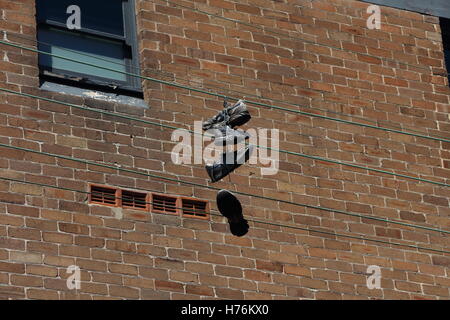 Trainers hanging from overhead lines Stock Photo