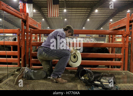 A young bull rider rodeo competitor prays before his ride at Palomino Fest in Uvalde, Texas. Stock Photo