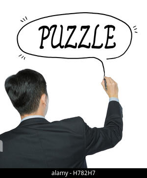 puzzle written by businessman in black suit, hand writing on transparent board, photo Stock Photo