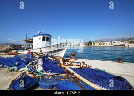 Traditional fishing boat in the harbour with fishing nets in the foreground, Caleta de Velez, Malaga Province, Andalusia, Spain, Stock Photo