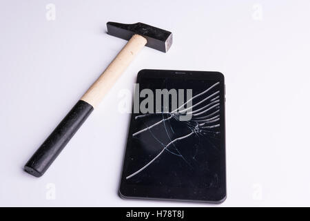 a tablet broken with the hammer Stock Photo