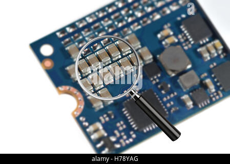 Clear image in magnifying glass against blurry close-up of a high speed M2 SSD storage drive isolated on white Stock Photo